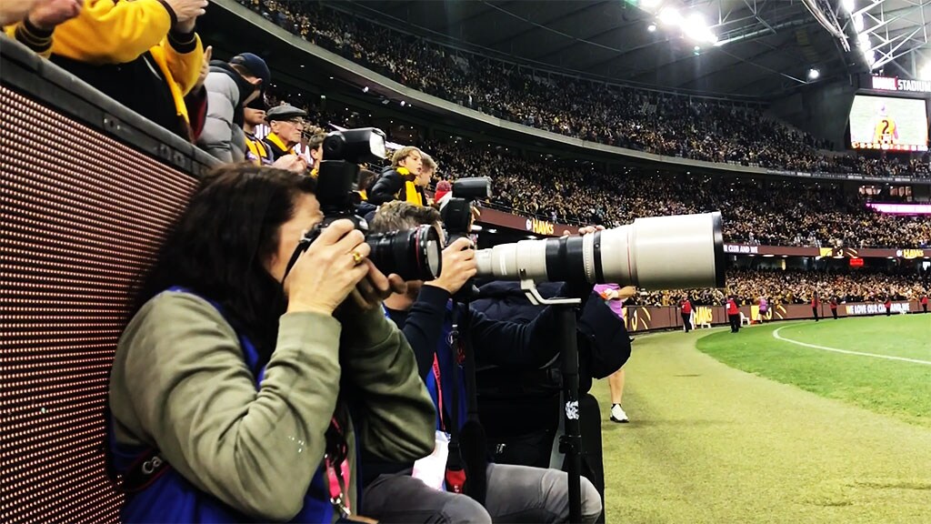 ADITLOMW14036PM.jpg Amber Noseda and Michael Willson on the boundary line during the Hawks' clash with the Suns - AFL